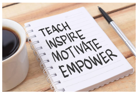 Notebook with words teach, inspire, motivate, empower.