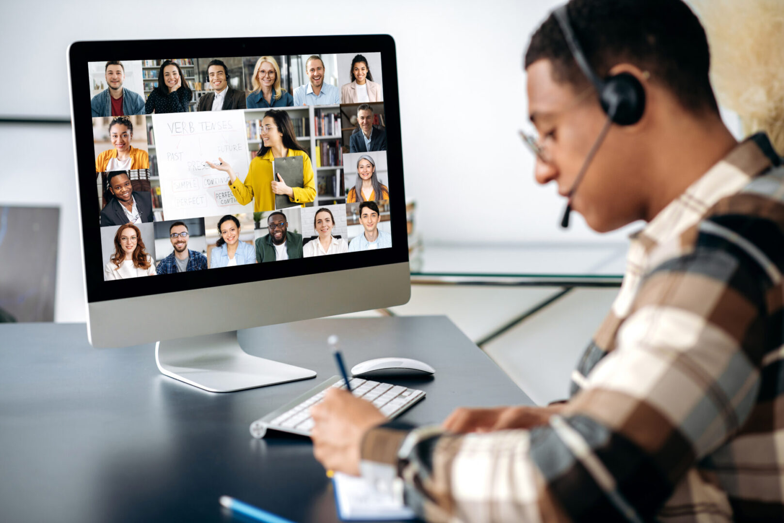 Man in online class with multiple students.