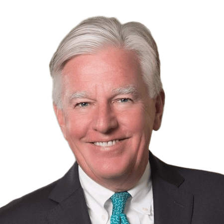 Elderly man smiling in a suit.