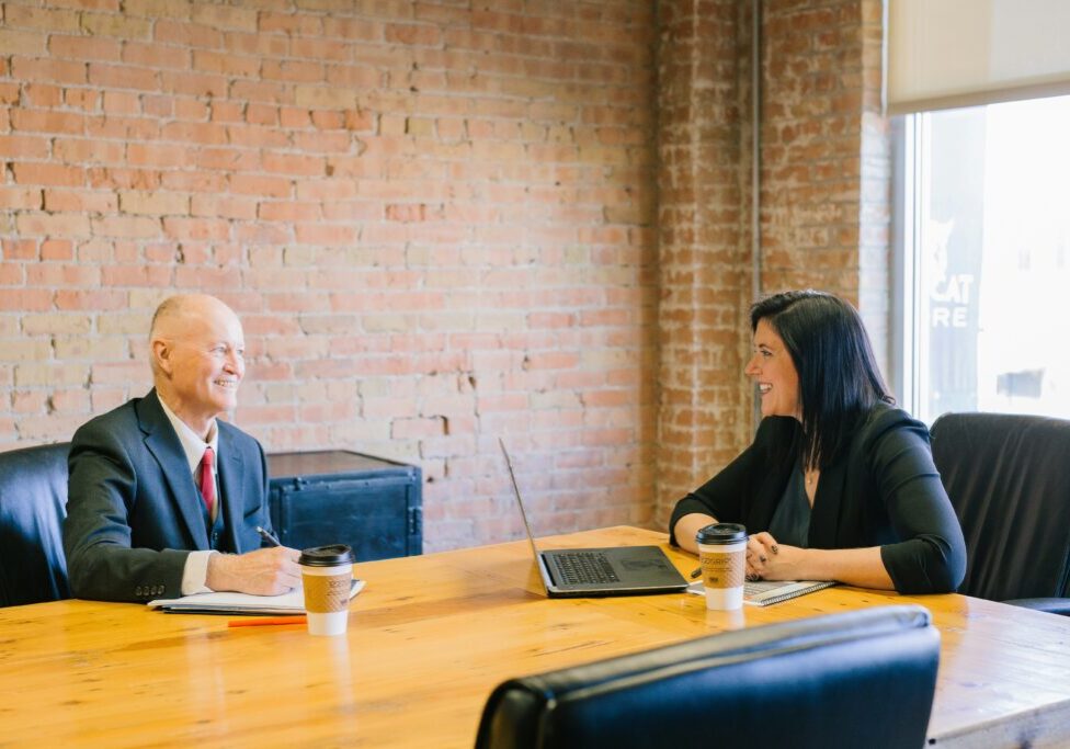 Two businesspeople meeting at a table.