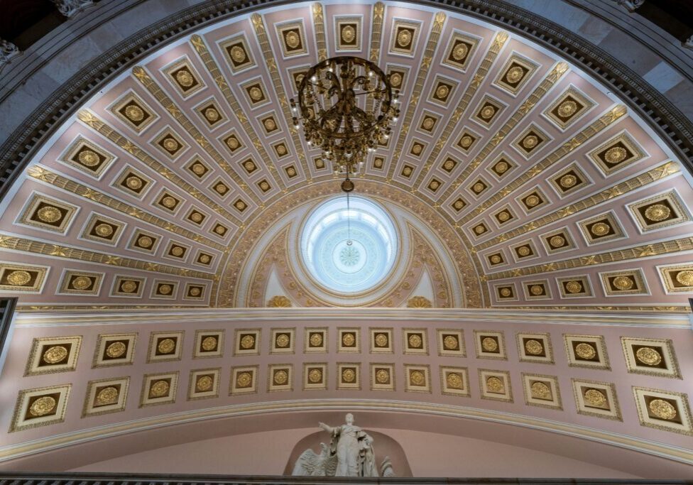 A ceiling with many gold and white tiles